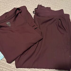 Insight Medcouture 
Burgundy scrub set shirt is a 4X pants are joggers 3X pants